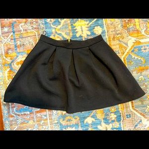 Black pleated mini skirt with gold zipper